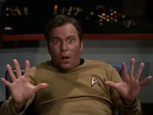 Captain Kirk holds his hands up in surprise